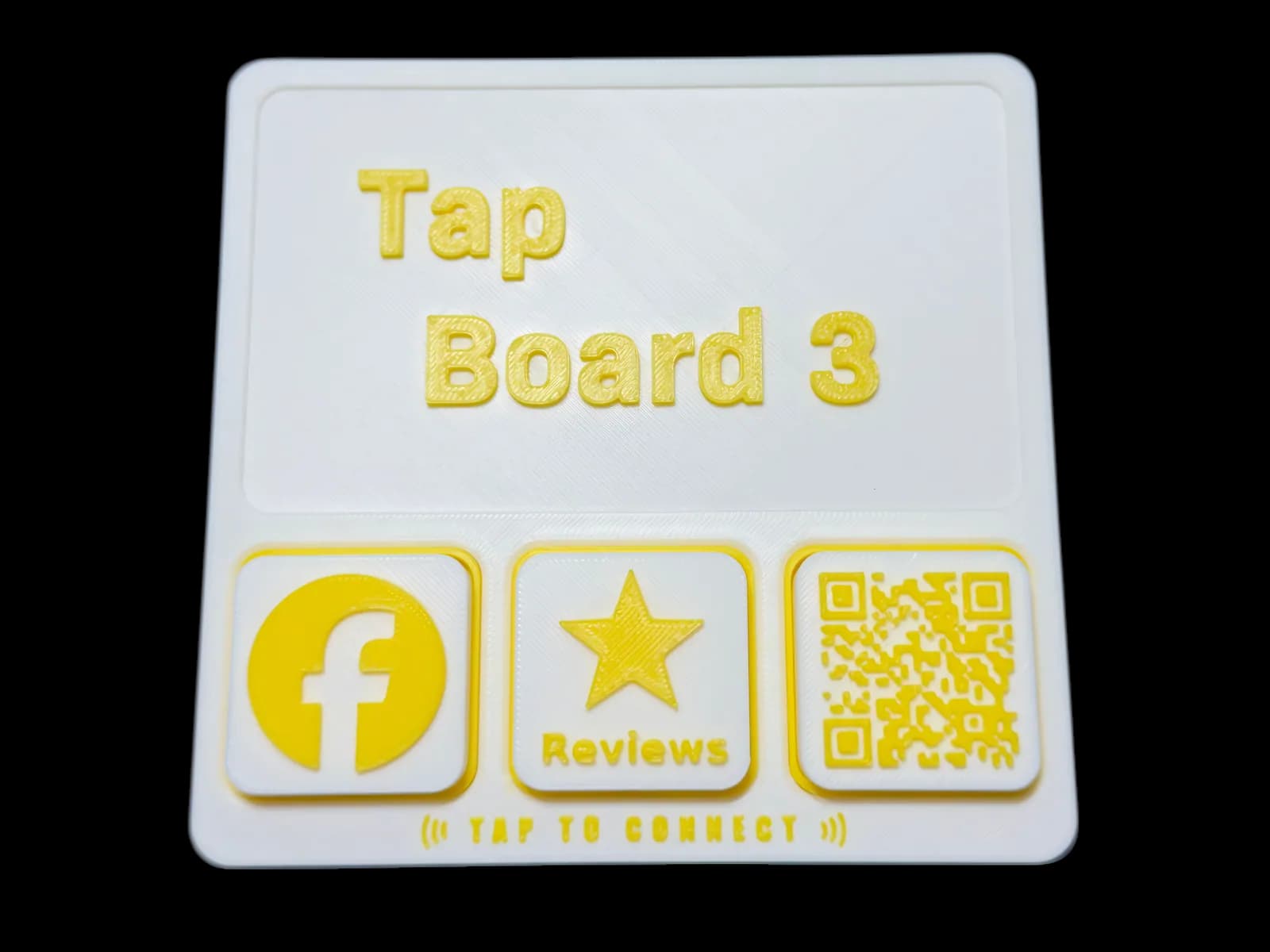Tap Board 3 flat on the counter with three tiles: Facebook, reviews and a QR code.