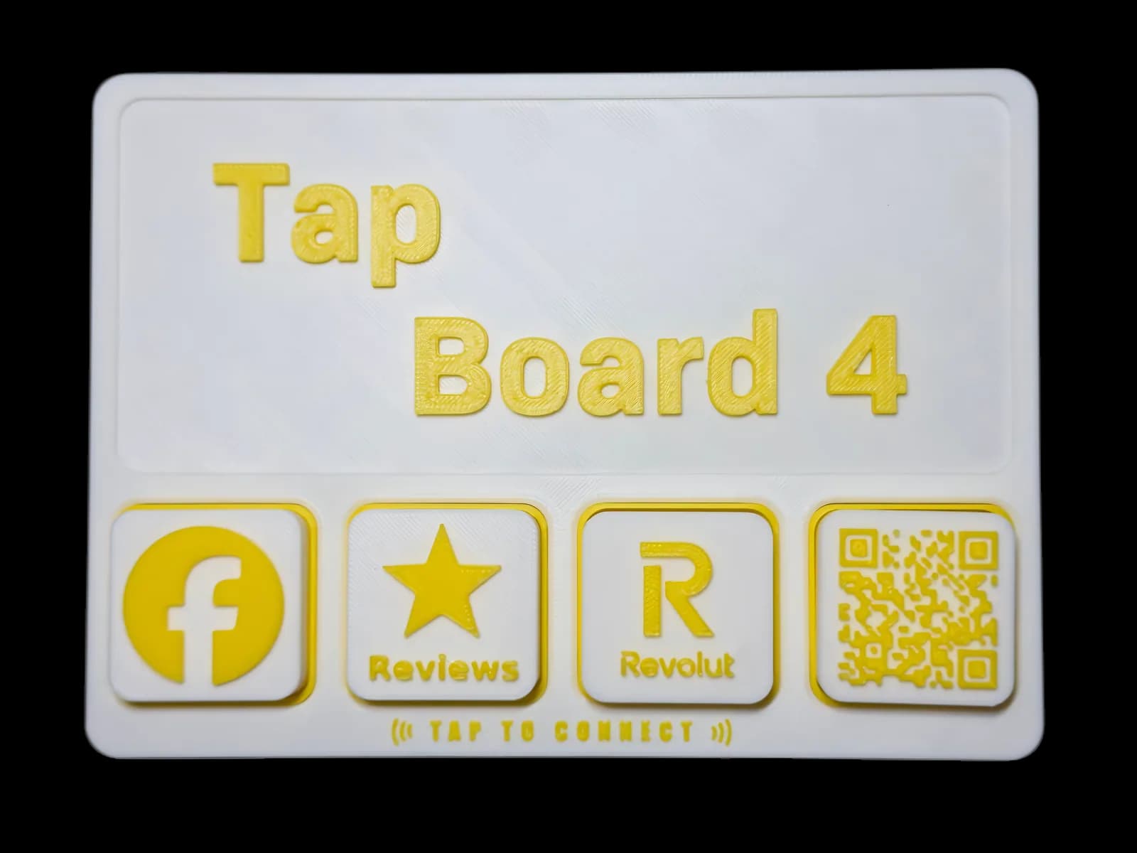 Tap Board 4 flat on the counter with four tiles: Facebook, reviews, Revolut and a QR code.